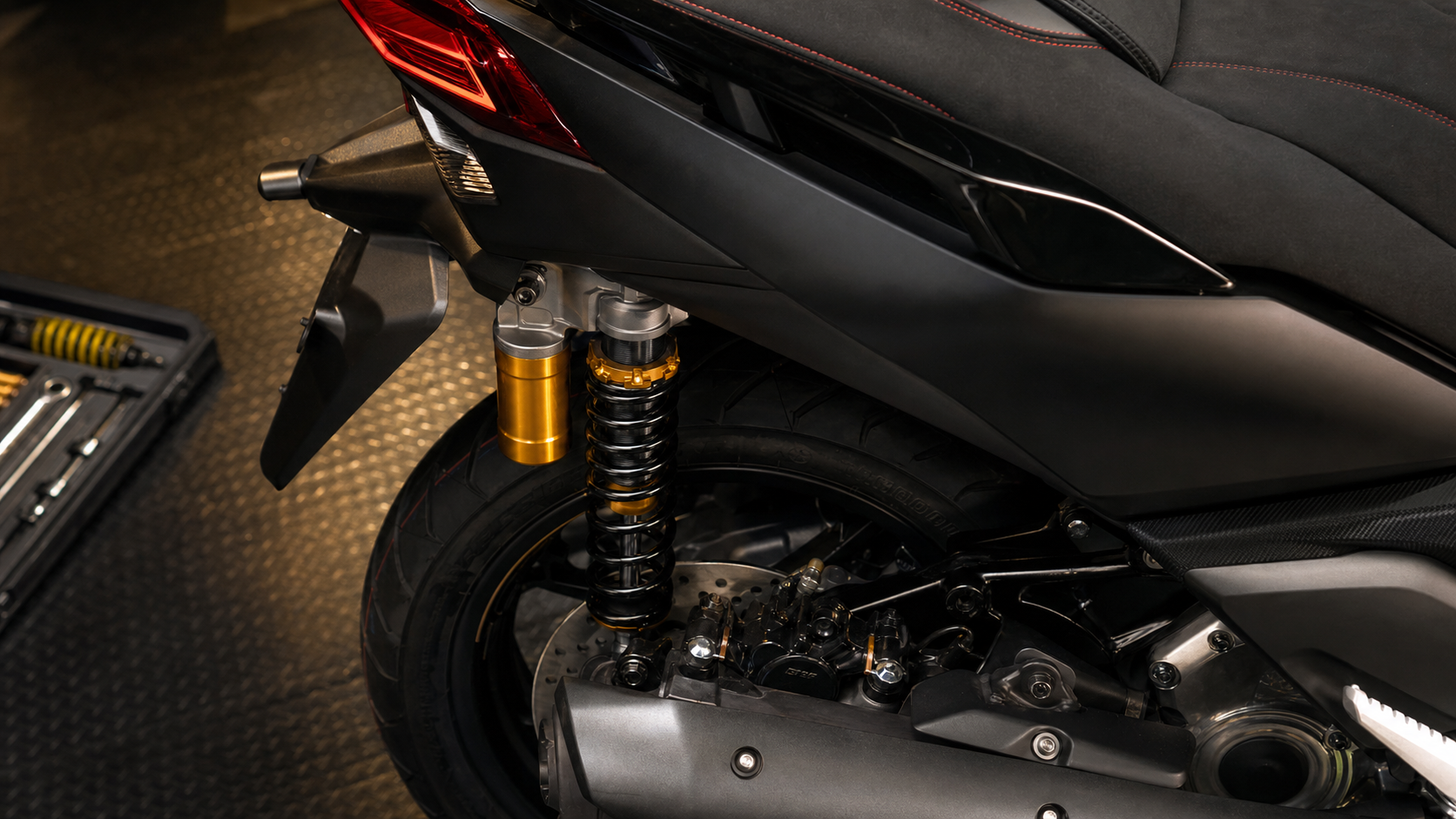 AI-generated close detail of Yamaha XMAX 25th Anniversary rear shock reservoir red stitching brake disc and tire inspection cues